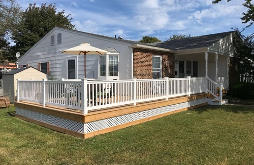 Village Green House | Beautiful corner property with cozy beach vibe.