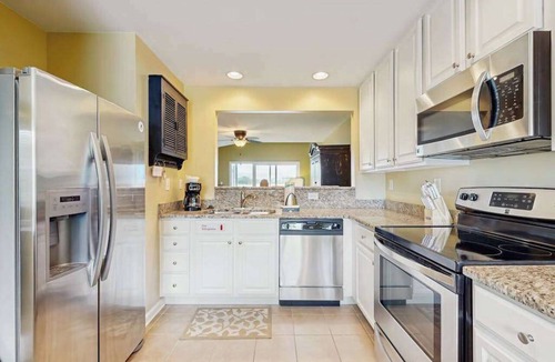 Ocean View Condo | Bethany Bay condo with bay views, athletic courts, pool, fireplace, & balcony