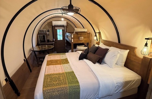 Pinnacles Entrance Badlands Hotel | Covered Glamping Wagons: Step Into the Frontier With Modern Comforts