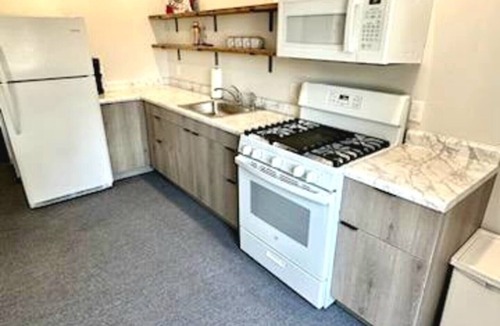 Arnolds Park Apartment | Cozy 2-bedroom suite with full kitchen, living room (couch, 2 chairs), dining table (2 stools), smart TV with cable. Perfect for short or long stays. This suite is one the 2nd level and requires guest to use stairs