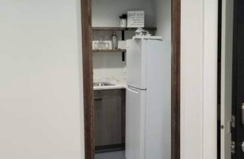Arnolds Park Apartment | Cozy 2-bedroom suite with full kitchen, living room (couch, 2 chairs), dining table (2 stools), smart TV with cable. Perfect for short or long stays. This suite is one the 2nd level and requires guest to use stairs