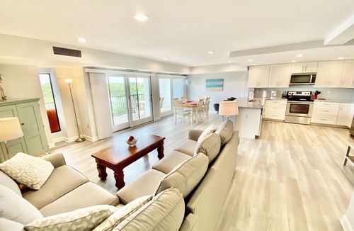 Rehoboth Beach Condo | LINENS & DAILY ACTIVITIES INCLUDED! OCEANFRONT/BOARDWALK BUILDING W/ROOFTOP POOL Completely remodeled kitchen with all-new cabinets and appliances, open floor plan and eat-at counter.