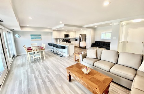 Rehoboth Beach Condo | LINENS & DAILY ACTIVITIES INCLUDED! OCEANFRONT/BOARDWALK BUILDING W/ROOFTOP POOL Completely remodeled kitchen with all-new cabinets and appliances, open floor plan and eat-at counter.