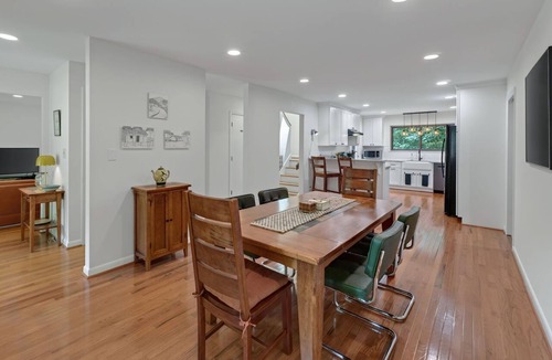 Charlottesville House | Settle into this stylish 4 bedroom, 3.5 bath midterm rental, thoughtfully designed with a warm midcentury modern vibe. Enjoy two primary suites, generous storage, a spacious deck, covered porch and private wooded backyard.