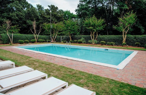 Gunter Afs House | Spacious 7BR home featuring a private pool, separate pool house, game room, Peloton-equipped workout sunroom, dedicated office, multiple living areas, and a fully equipped kitchen—perfect for families, groups, and extended stays.