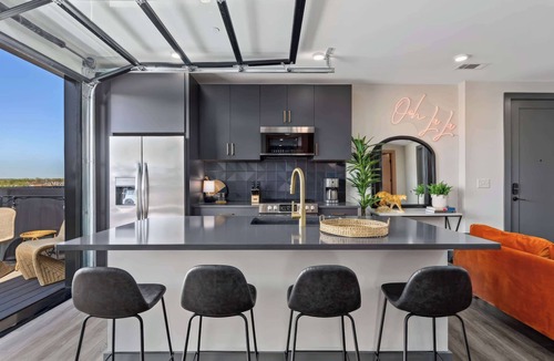 Rolling Mill Hill Apartment | Summer rooftop deck, skyline views, garage-door kitchen near Broadway