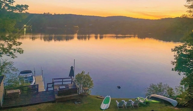 Lakefront home near ski resorts with water view, dock, deck, fireplaces, & W/D