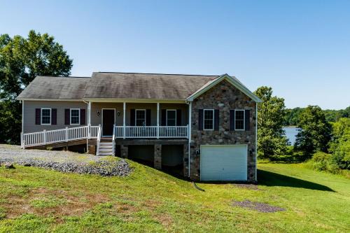 Two-story, lakefront getaway with dock, beach, grill, 2 kayaks, 2 canoes, AC